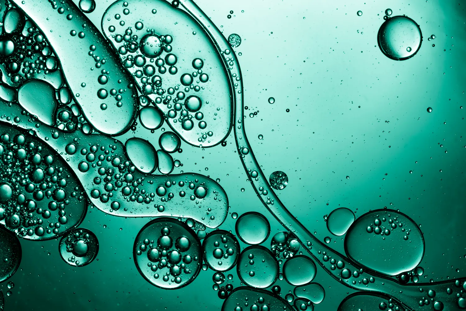 Abstract swirl of teal paint and oil