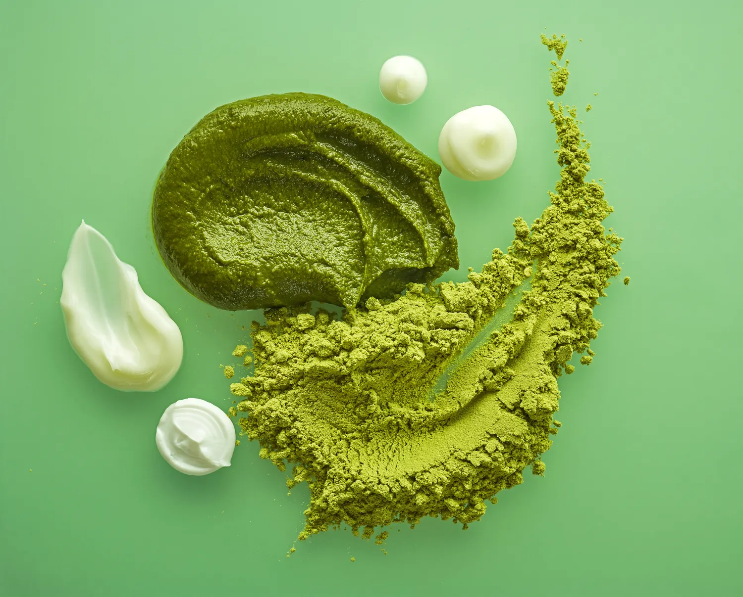 Green and white creamy cosmetic product swatches